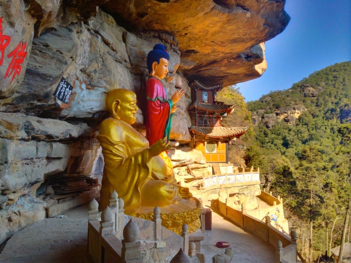 Guanyin and Maitreya, the smiling Buddha, on the cliff ledges at Baoxiang Temple