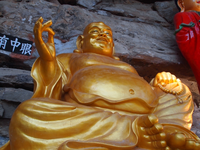 Maitreya, the smiling Buddha, on the cliff ledges at Baoxiang Temple